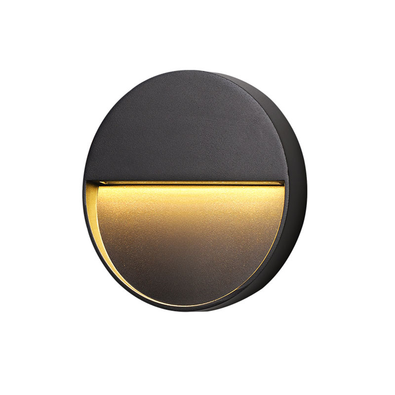 Black round shielded outdoor staircase light on a white background